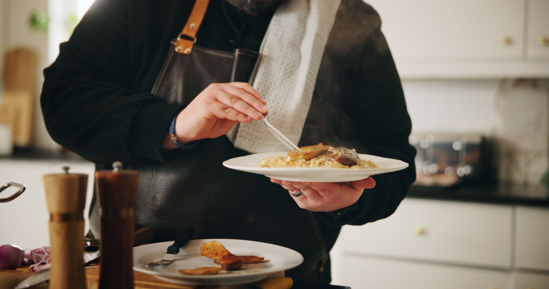 Cooking, food or hands of chef with plate in kitchen of home for diet, private service or nutrition. Ingredients, recipe or closeup of man with dish in house for gourmet cuisine, hospitality or lunch